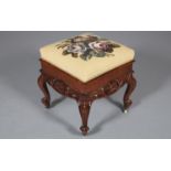 A VICTORIAN WALNUT STOOL, of square outline having a floral needlework seat to the hinged top, the
