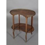 A LATE 19TH CENTURY FRENCH MAHOGANY AND GILT METAL MOUNTED TWO TIER TABLE OF KIDNEY SHAPE, having