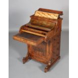 A VICTORIAN FIGURED WALNUT DAVENPORT having a rising stationery compartment above a piano front with