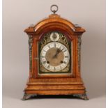 A LATE 19TH CENTURY GERMAN OAK AND GILT METAL MOUNTED BRACKET CLOCK of semi arched outline, the