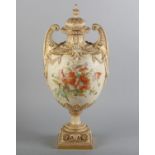 A ROYAL WORCESTER BLUSH IVORY TWO-HANDLED VASE AND COVER, by Edward Raby, shape 1398, c.1891, the