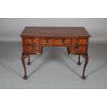 AN EARLY 20TH CENTURY MAHOGANY DESK, of serpentine outline with gadroon rim, having a drawer to