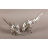A PAIR OF SILVER COCK AND HEN PHEASANTS, German import mark for 1933, naturalistically modelled,