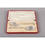 A PAIR OF EDWARD VII SILVER FRUIT SERVING SPOONS with shell bowls and spiral handles, the seal