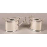 A PAIR OF EDWARD VII OVAL SILVER MUSTARD POTS each with domed cover, reeded scroll handle, three