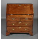 A GEORGE III MAHOGANY BUREAU having a fall front with fitted interior of small drawers, pigeon holes