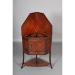 AN EARLY 19TH MAHOGANY CORNER WASHSTAND the lift up top angled to become a panel back, above