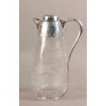 A VICTORIAN SILVER MOUNTED GLASS CLARET JUG, Ephraim Tysall, London 1887, engraved with a huntsman