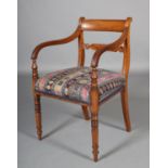A LATE REGENCY MAHOGANY CARVER having a tablet top rail and tie rail, upholstered seat, turned