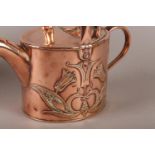 AN ART NOUVEAU COPPER HOT WATER CAN of oval outline embossed with plant forms to opposing sides,