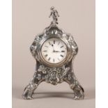 AN EDWARD VII SILVER CASED MANTEL CLOCK, Wm Comyns & Sons, London 1902, of arched outline with