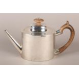 A GEORGE III SILVER TEAPOT OF OVAL FORM with domed cover, tapered spout and chased with bands of