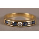 A SAPPHIRE AND DIAMOND SET HALF HOOP RING IN 18CT GOLD, the brilliant cut diamonds and circular