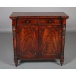 A MID 19TH CENTURY FIGURED MAHOGANY CUPBOARD with inverted breakfront, having two dummy drawers with