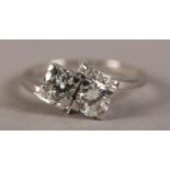 AN ART DECO TWO STONE DIAMOND RING IN PLATINUM, the brilliant cut stones claw set in square box