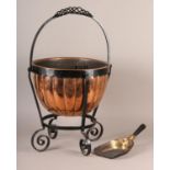A LATE VICTORIAN COPPER AND WROUGHT IRON COAL VASE, the lobed body held in a frame with swing handle
