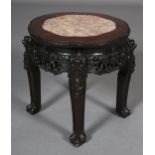 A LATE 19TH CENTURY CHINESE HARDWOOD AND INSET MARBLE URN STAND, circular with beaded rim, carved