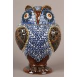 A DOULTON LAMBETH STONEWARE OWL JAR AND COVER in relief and glazed in sliver green, brown, blue