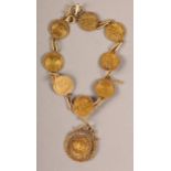 AN EARLY TO MID 20TH CENTURY BRACELET of facsimilie coins in yellow metal (tests as 9ct gold),
