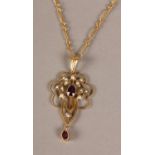 AN EDWARD VII RHODOLITE GARNET AND SEED PEARL PENDANT IN 9CT GOLD, the oval faceted garnets collet