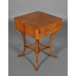 AN AMERICAN SATINWOOD AND GILT METAL MOUNTED WORK TABLE OF SQUARE OUTLINE with canted corners,