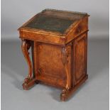 A VICTORIAN FIGURED WALNUT DAVENPORT having a pierced brass gallery above a sloping top incised with