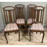 A SET OF FOUR ARTS AND CRAFTS OAK DINING CHAIRS with broken arch back, inlaid to splat in pewter and