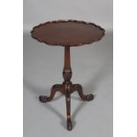 A 19TH CENTURY MAHOGANY TRIPOD TABLE, circular of bracketed outline, on a fluted, foliate and vase