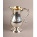 A GEORGE III SILVER BALUSTER ALE JUG, Hester Bateman 1786, engraved with a crest, an arm embowed