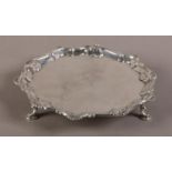 A GEORGE III SILVER WAITER, London 1776, circular with piecrust and shell rim, engraved to the
