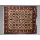 A FINE CAUCASIAN HANDMADE RUG the ivory field with stylised flowers and trees on a camel ground with