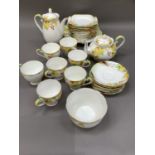 A Royal Grafton china tea service decorated with leaves and berries in yellow, green and iron red,