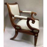 A reproduction mahogany Regency open armchair having moulded frame with gilt paterae, upholstered