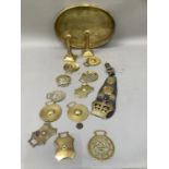 A quantity of mainly 19th century horse brasses, strung on a leather strap, including Victoria's