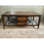 A mahogany finished coffee table with drawers to both sides with brass handles and flanked by open