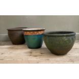 Three various garden planters including terracotta, green and ochre glazed and a stoneware with