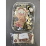 A tub of miscellaneous English and foreign obsolete currency, plus three ten Shilling notes