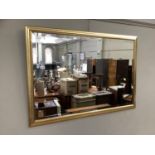 A gilt framed rectangular wall mirror with bevelled glass, 70cm by 100cm