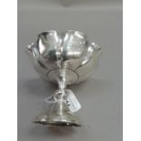 An Edward VII silver bonbon dish of fluted outline raised against a baluster stem, Hallmarked London