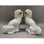 A pair of 19th century Staffordshire spaniels with painted features and gilt detailing,