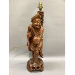 A late 19th century Chinese root carving of a male figure as a lamp