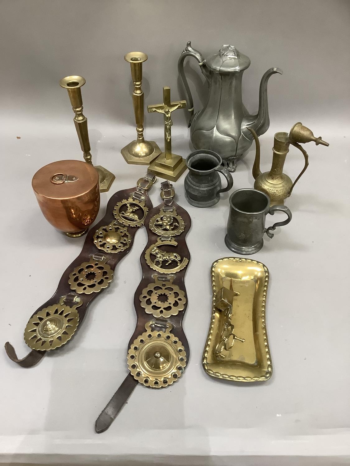 A leather strap with horse brasses, brass snuffer and tray, pewter coffee pot and mugs, pair of