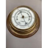 An aneroid barometer by John Barker & Co Ltd, Kensington, brass cased and oak mount (glass cracked),