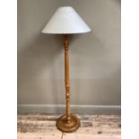 A beech reeded standard lamp with cream shade and two other shades