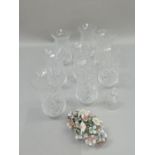 A set of eight cut glass candle lamp shades, a table bell and a flower cluster