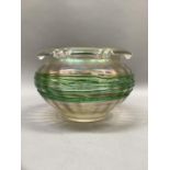 A late 19th century iridescent glass bowl having a fold over and crimped rim and applied green