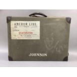 A leather dressing case in canvas outer covering lettered Johnson, with luggage label for Anchor
