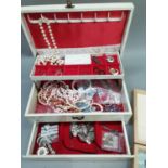 A cream vinyl covered jewellery box and a ply wood box both containing a quantity of costume