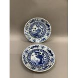 A pair of 19th century Chinese blue and white saucers painted to the centre with rocks issuing peony