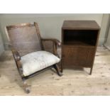 An oak veneer bed side cupboard together with a begere cane bedroom chair with upholstered seat